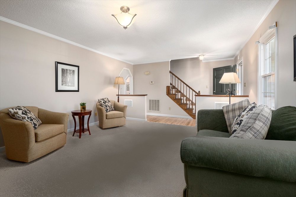 The same carpet before cleaning, greyed and dulled where people walk