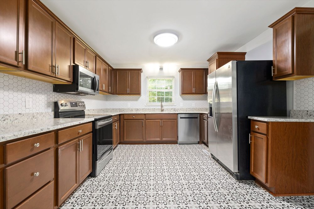 A patterned kitchen tile floor after cleaning, with even, light grout lines